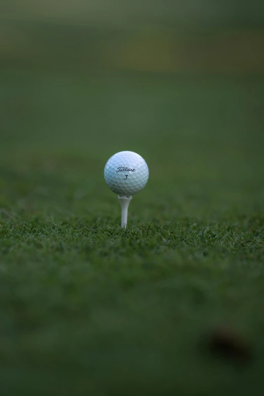 the ball is sitting on top of a tee