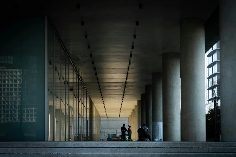 two people walking along an outdoor walkway in an industrial area