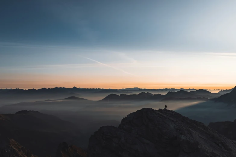 mountains covered in mist and low clouds at dawn