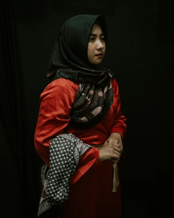 a woman wearing a shawl and dress is posing