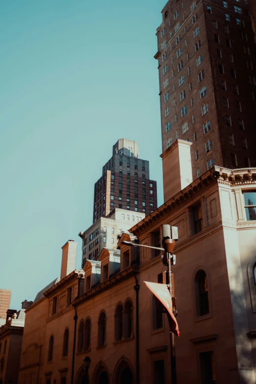 a tall building with a clock on top against a clear blue sky