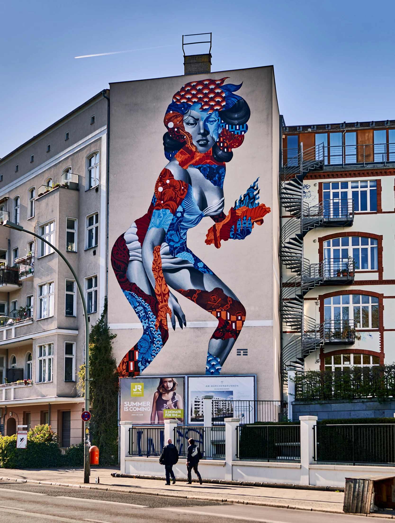 a woman painted on the side of an apartment building