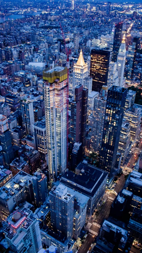 new york city at night looking down on the skyscrs