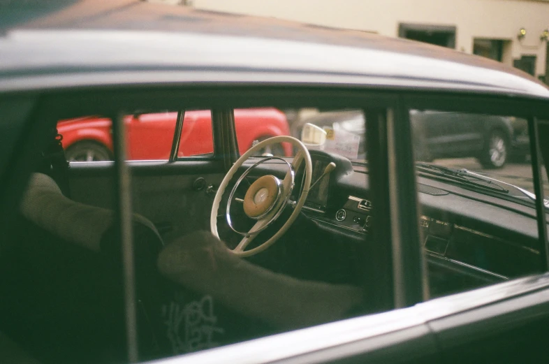 car dashboard with wooden spokes and old steering wheel