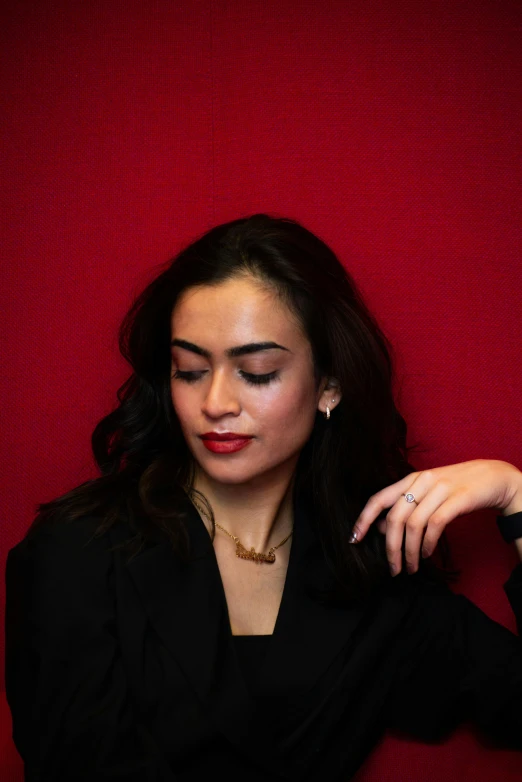 woman with jewelry and red curtain over red background