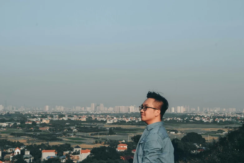 a man in a suit looking out at the city