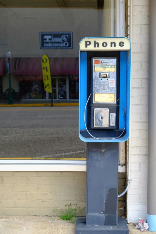 a phone box is sitting outside the store