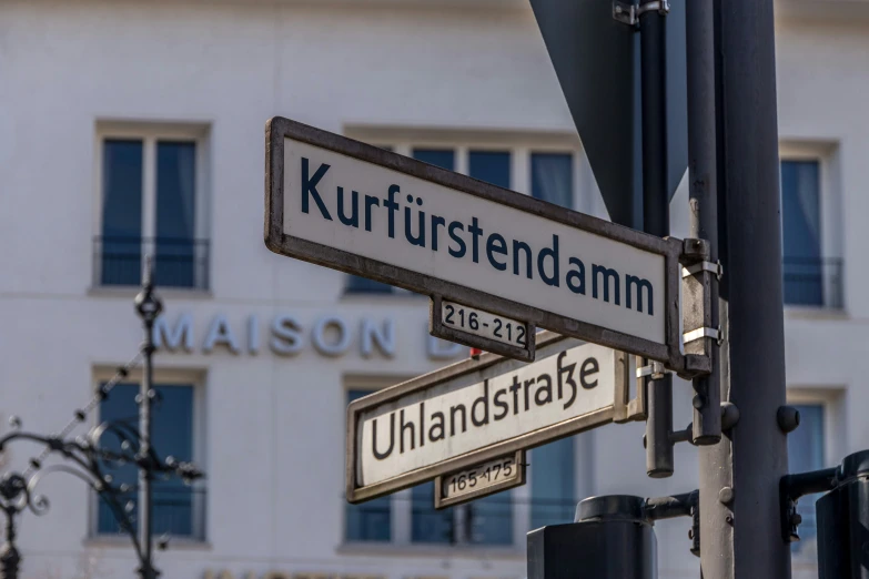 several street signs pointing in different directions on a pole