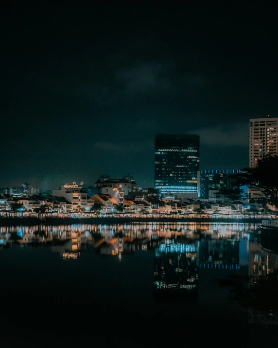 a view of a city by the water at night