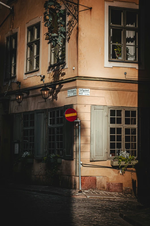 a building with windows and a street sign in front