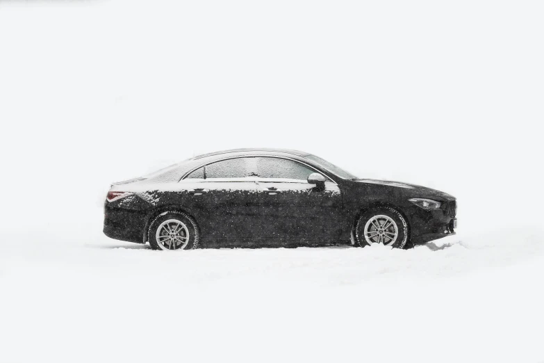 a black car in the snow covered with snow