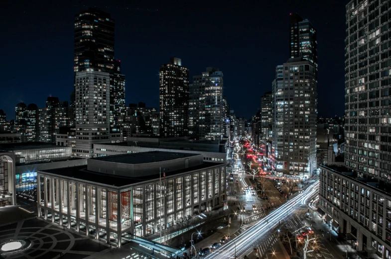 an aerial view of city at night showing the lights of traffic