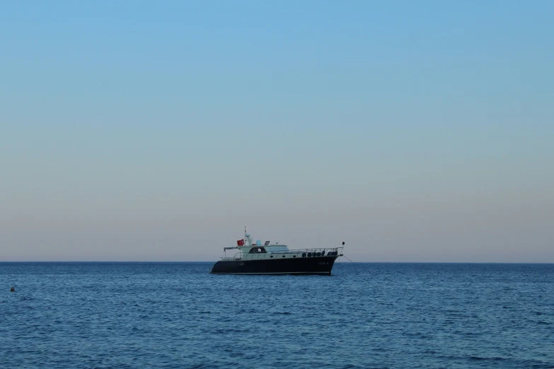 a boat in the open water, with a person on board