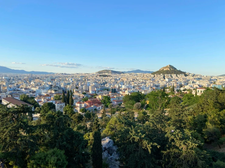 a view of a hill that has trees in the foreground