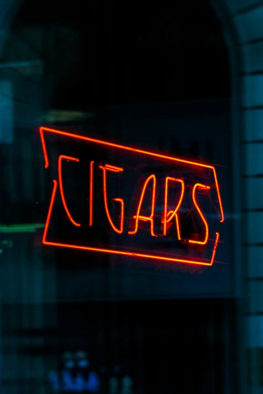 a neon sign that says sugars lit up on the outside of the building