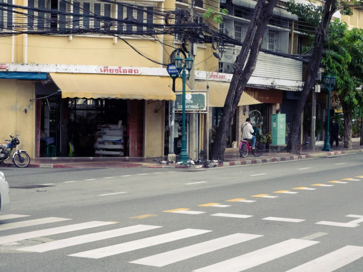 a street corner with a car driving down the street