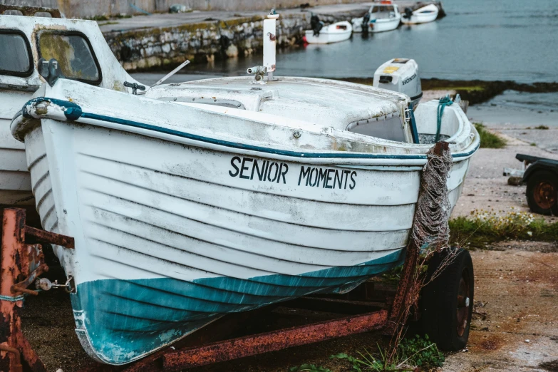 two fishing boats are parked side by side on the beach