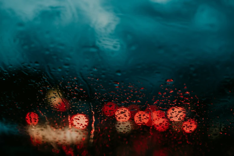 a blurry picture of a wet windshield in the rain