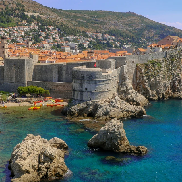 a rocky coast with blue water and clear blue water