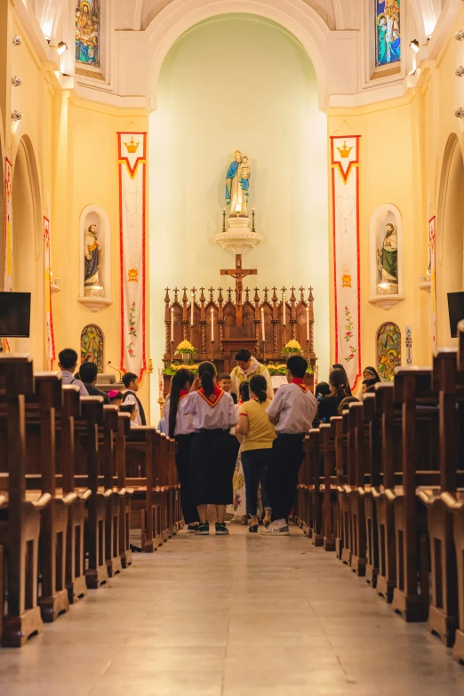 a man walking down a walkway near the alter of a church