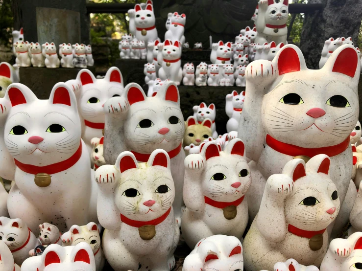 many white statues with cats on display
