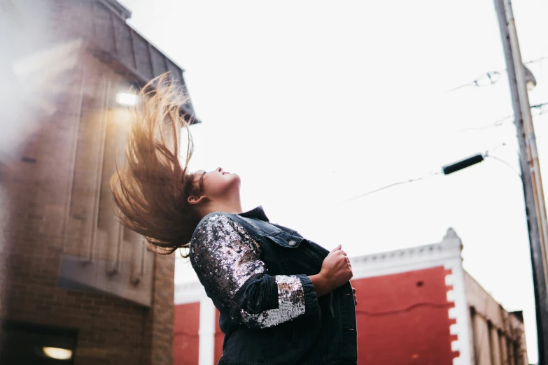 a woman posing with her hair flying in the air