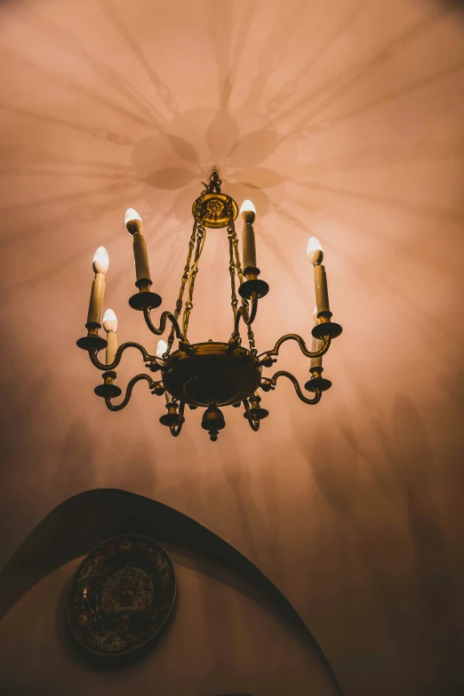 a chandelier on the ceiling with some small candles coming out