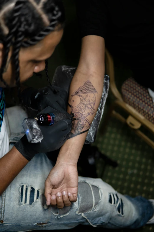 a man with a tattoo and a white t - shirt on