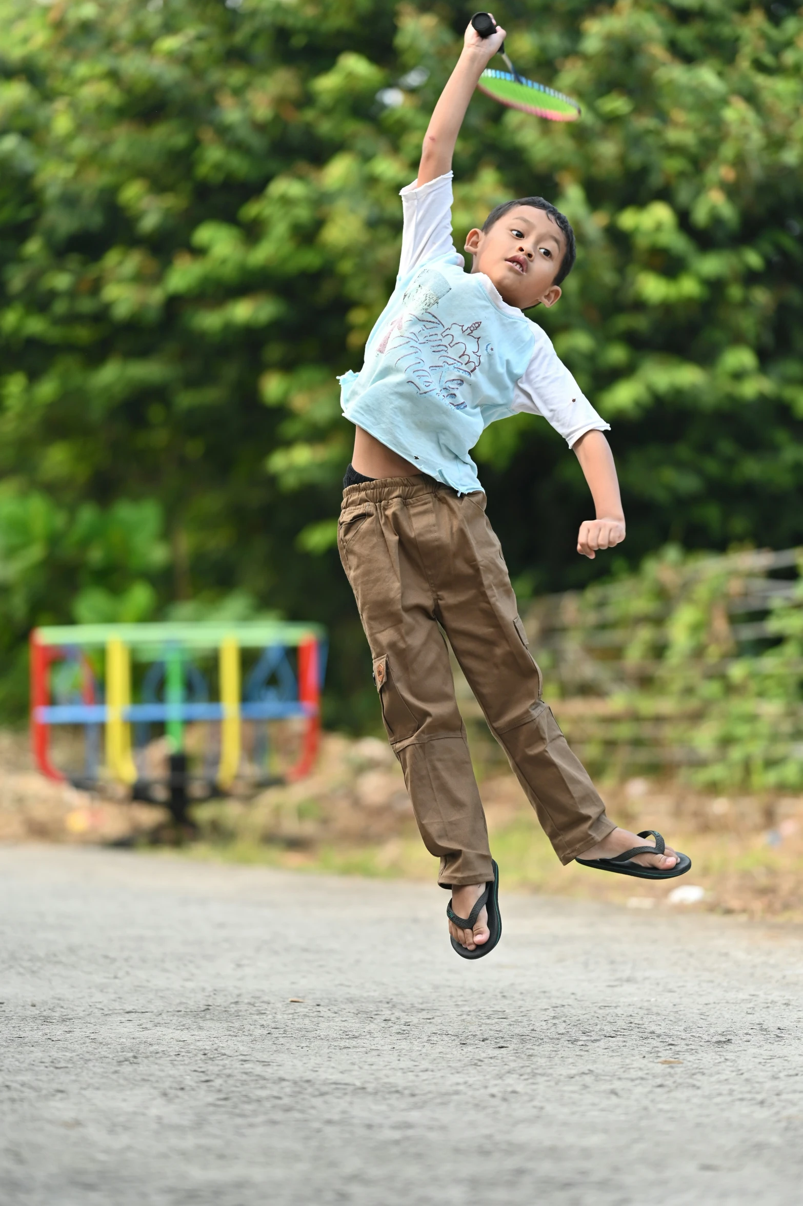 a boy jumping in the air holding onto his arms