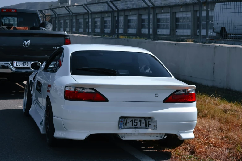 the white car has two wheels on it's bed