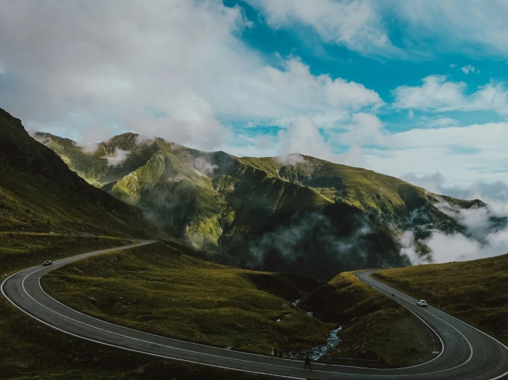 aerial view of a highway winding through a mountain