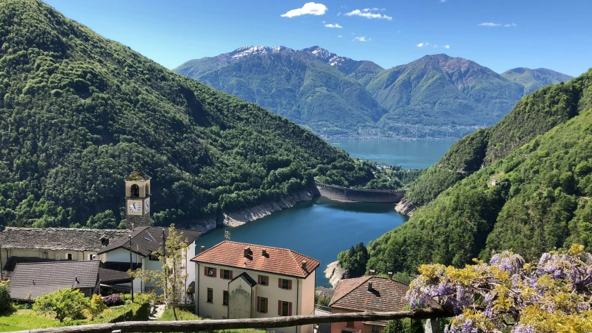 an old house sits on the side of a mountain overlooking a lake