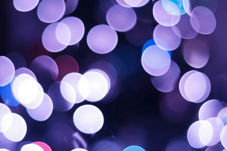 an image of colorful and blurred lights on a dark background