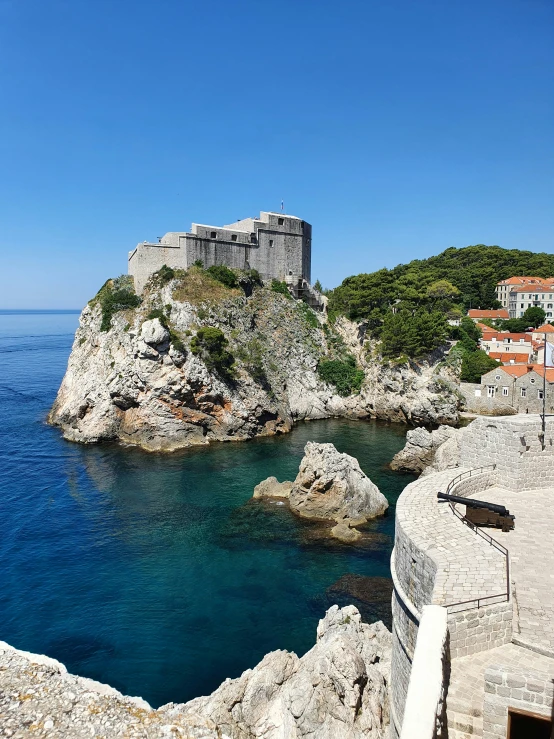 an ocean view with a castle on top of a hill