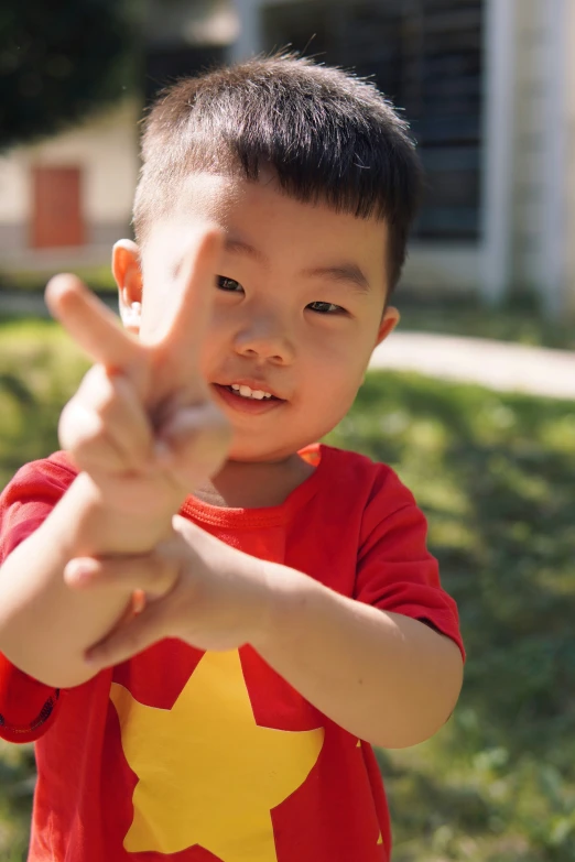 a  in a red shirt shows his two fingers