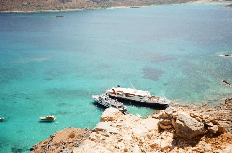 boat anchored in bay surrounded by clear water