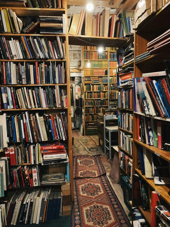 rows of books in a liry with man standing inside of one