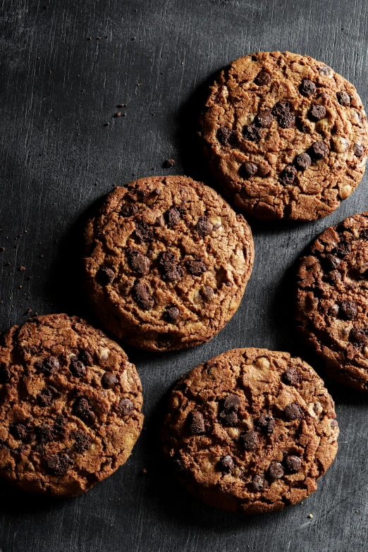 a group of cookies on a dark surface