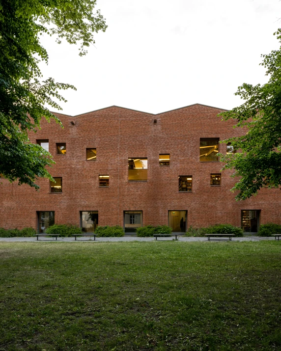 the tree is next to a building made out of bricks