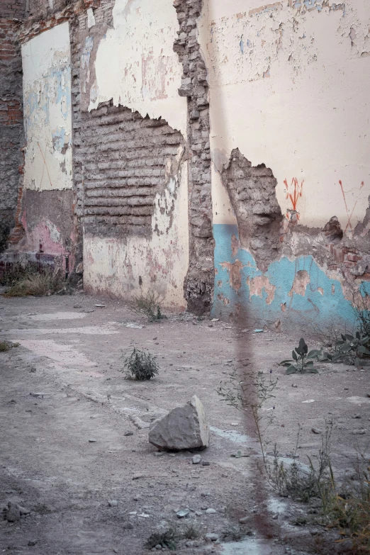 a large piece of wall sitting next to a sidewalk