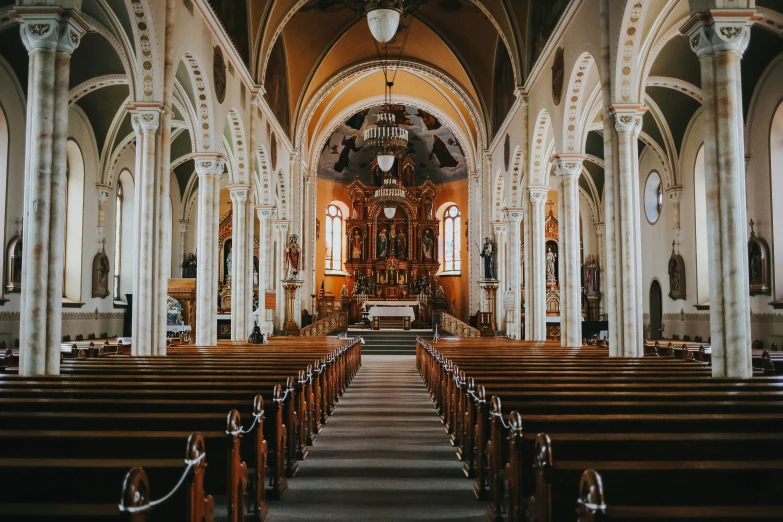 the inside of a church with a row of pews