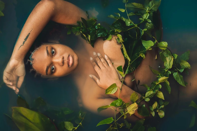  woman laying down on top of plants