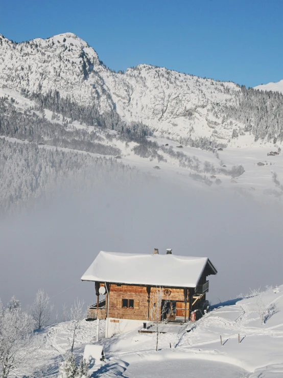 a cabin on the side of a snowy mountain