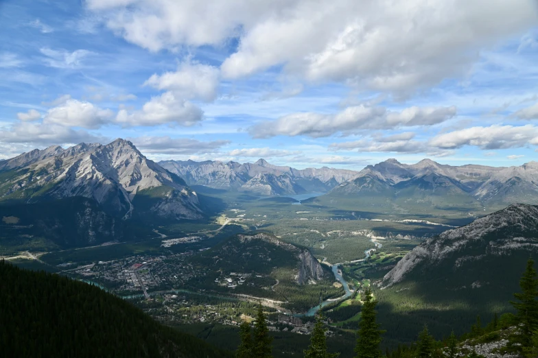 the valley below is surrounded by pine trees