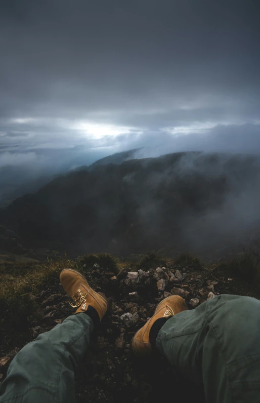 a person is standing near some rocks in front of a fog