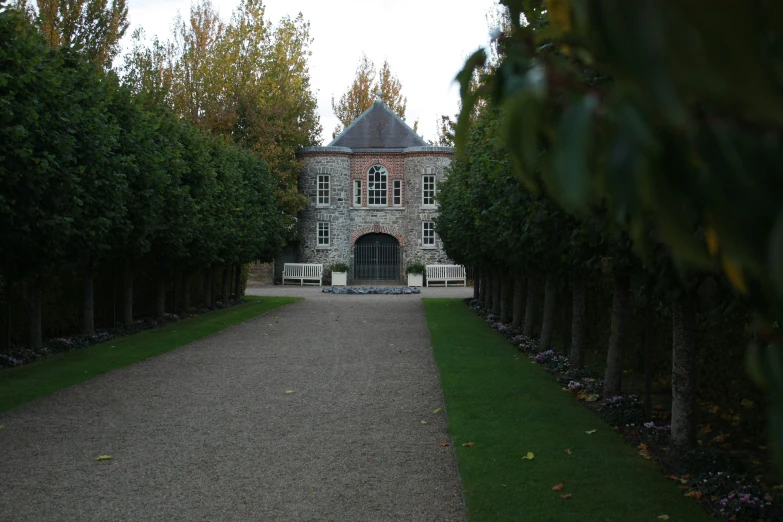 the view of a long driveway in front of a house