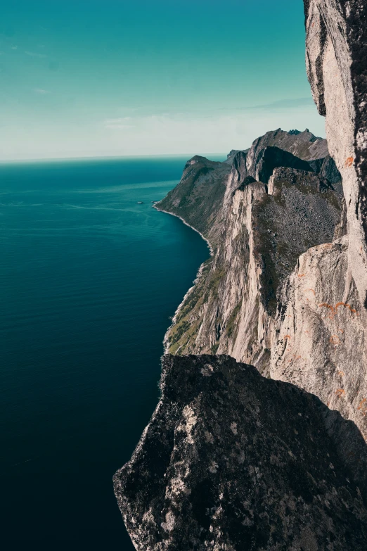 a person standing on top of a large cliff