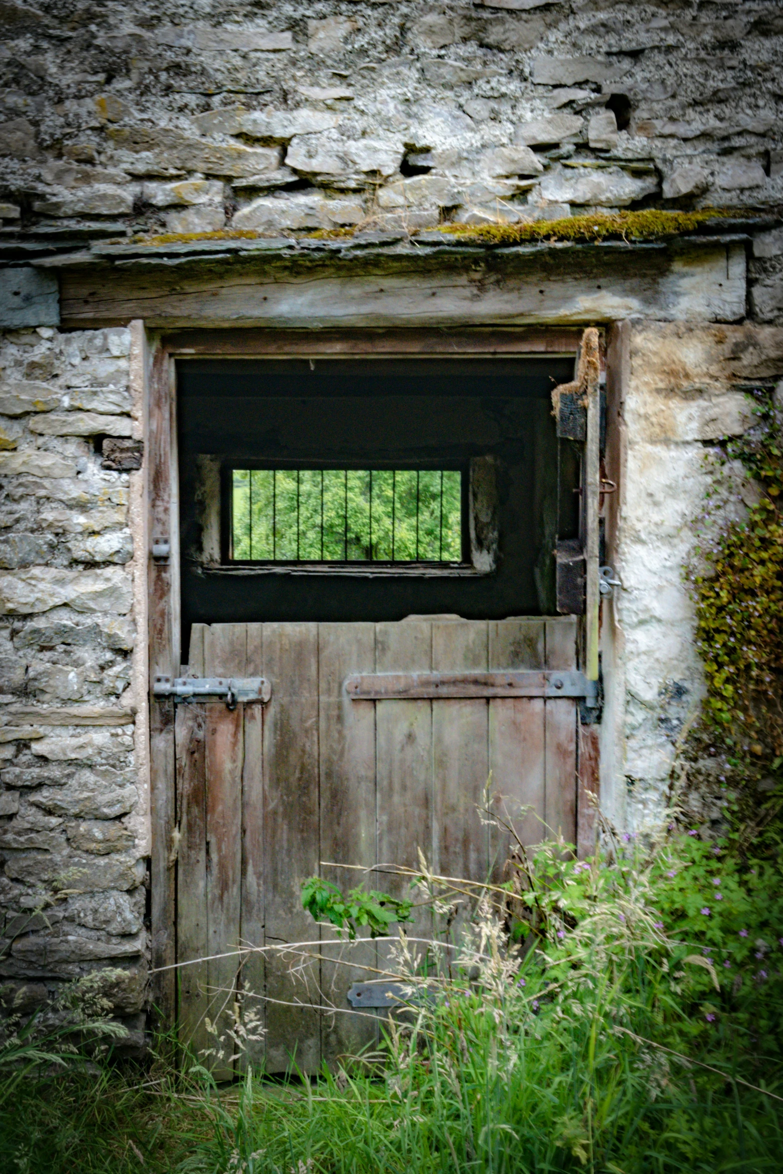 the door is open outside of the old stone building