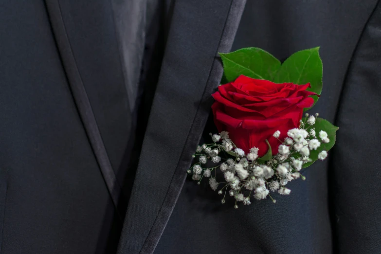 the red rose was made with a single red rose, tiny baby's breath and other things