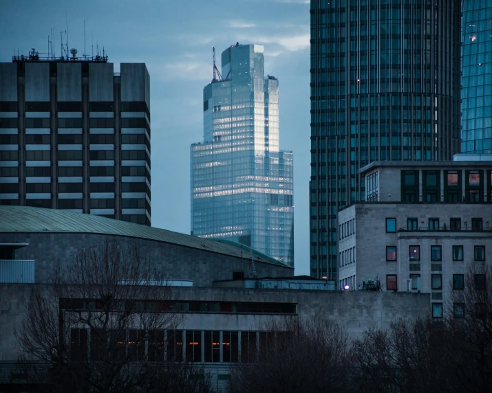 a dark po of the glass and metal skyscrs